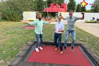Vertreter der beiden Sponsoren und Gartenschaupark-Geschäftsführer hüpfen auf einem der neuen Trampoline.
